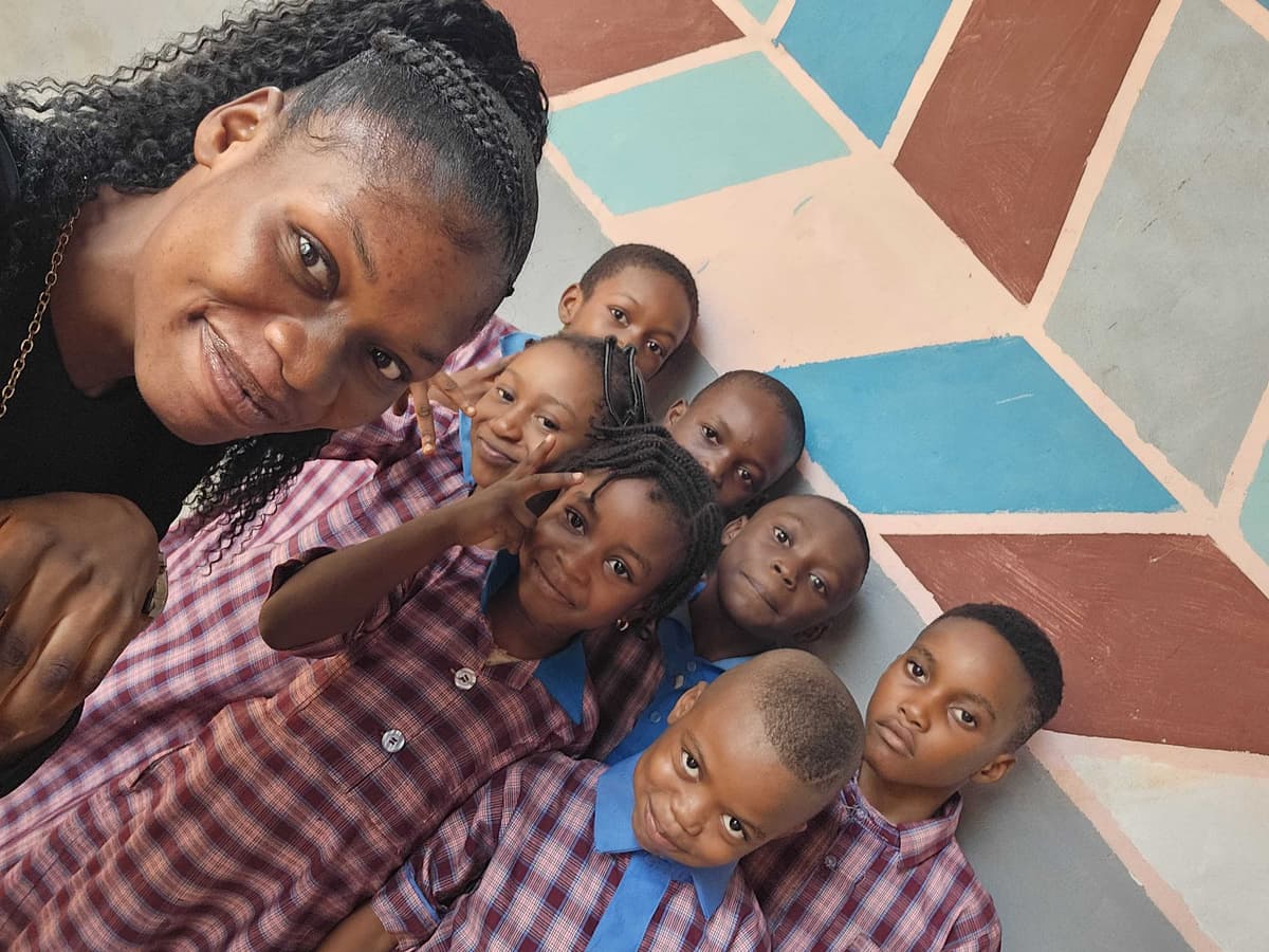 A staff member with HAFAMA Early Years pupils